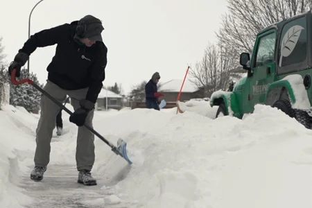 shoveling snow on sidewalk