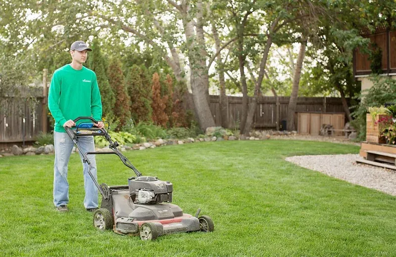 technician mowing a lawn